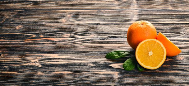 Orange on a wooden background. Top view. Free space for text. - Foto, imagen