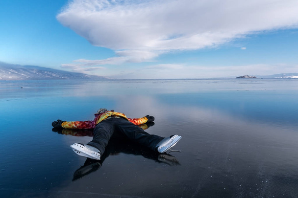 Girl tourist lies on the ice of Lake Baikal - Photo, Image