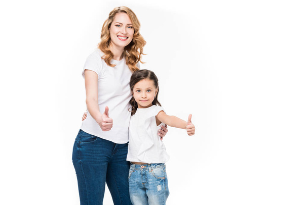 portrait of smiling mother and daughter showing thumbs up isolated on white - Foto, Bild