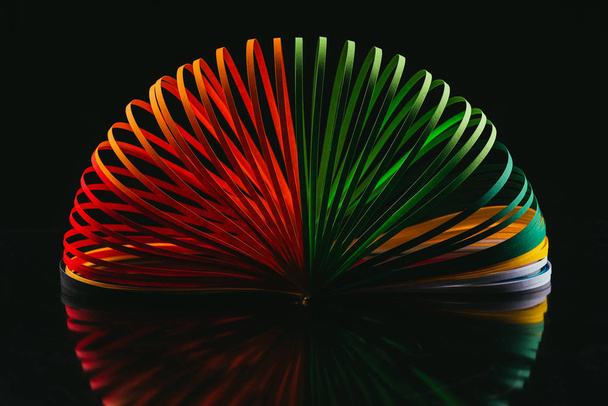 colored quilling paper curves on black - Fotoğraf, Görsel