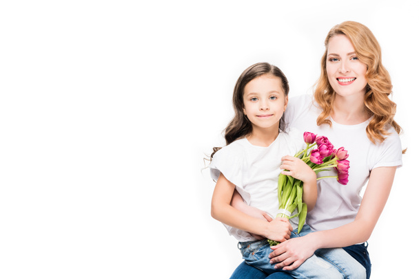 happy mother and little daughter with bouquet of flowers isolated on white, mothers day holiday concept - Zdjęcie, obraz