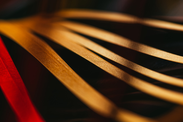 close up view of yellow quilling striped paper on black  - Foto, immagini
