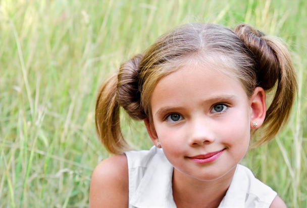Portrait of adorable smiling little girl in summer day  - 写真・画像