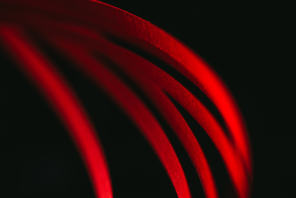 close up view of red quilling striped paper on black  - Foto, immagini