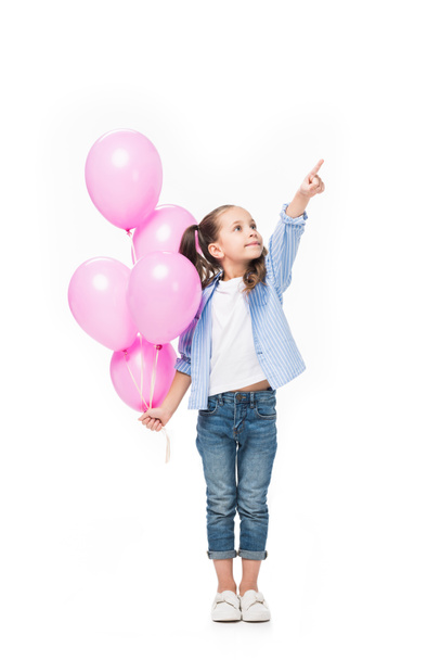 adorable little kid with pink balloons pointing away isolated on white - Fotografie, Obrázek
