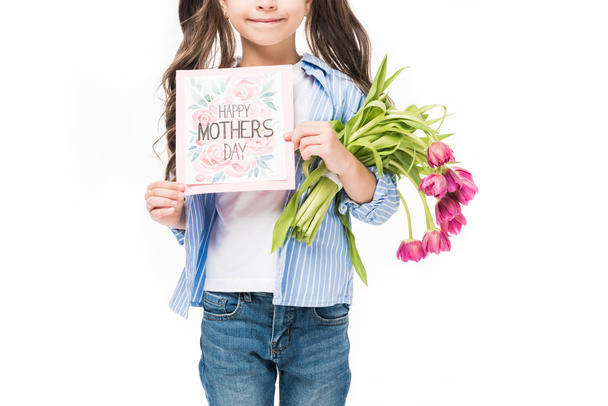 cropped shot of kid with happy mothers day postcard and bouquet of flowers isolated on white - Фото, зображення