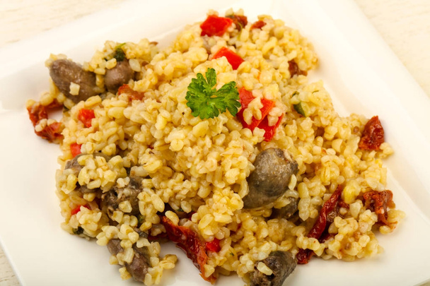 Bulgur with chicken hearts and dry tomatoes - Photo, Image