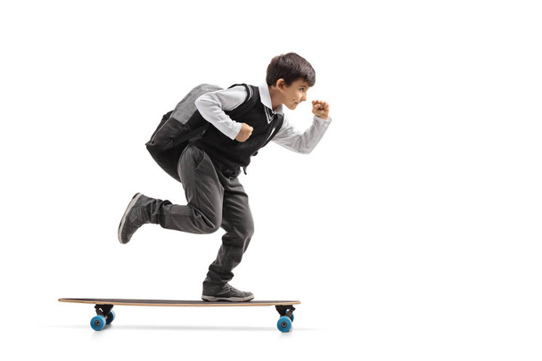 Schoolboy riding a longboard - Foto, Imagen