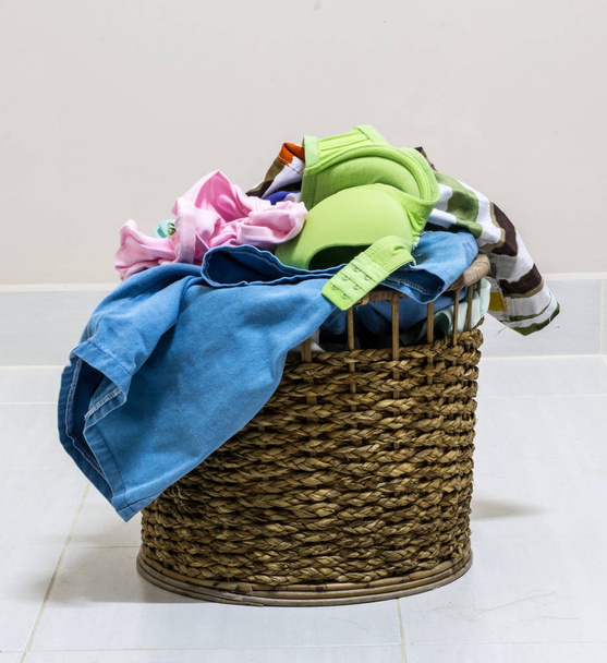 hromada špinavého prádla v mycí koše na bílém pozadí - Fotografie, Obrázek