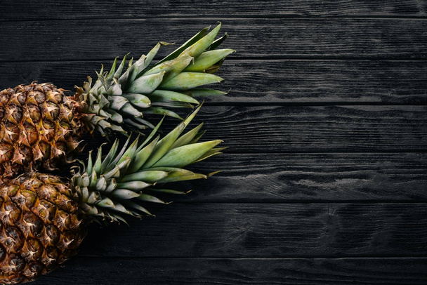 Pineapple on a wooden background. Top view. Free space for text. - Foto, Imagen