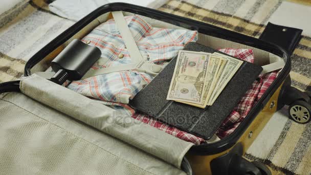 A man collects things on the road, puts a purse with money in his suitcase - Footage, Video