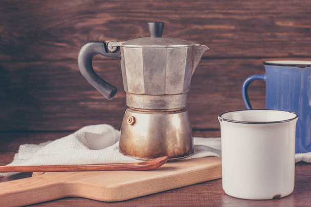 old coffee pot, two mugs, wooden table - 写真・画像