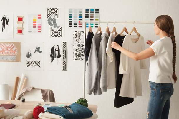 Female fashion designer working on new womenswear collection in - Foto, Bild
