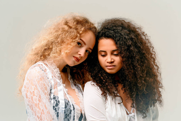 Portrait of two curly girls. Afro and blond - Foto, imagen