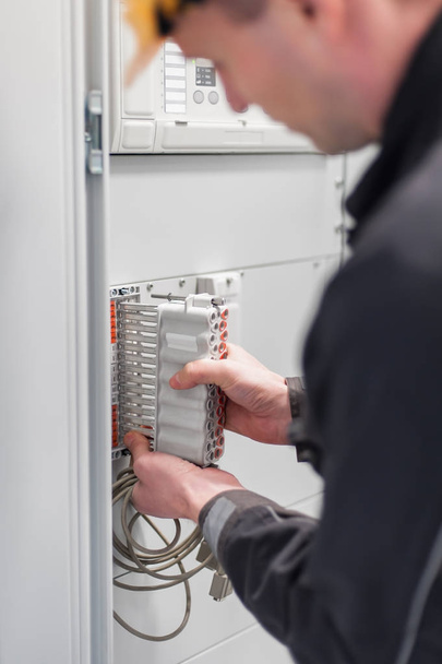 Electrician engineer tests electrical installations on relay pro - Photo, Image