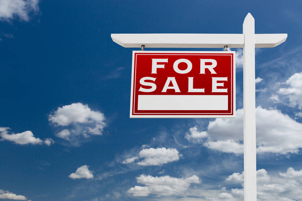 Izquierda frente a la venta inmobiliaria firmar sobre cielo azul y nubes con espacio para su texto
. - Foto, Imagen