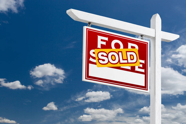 Izquierda Orientación Vendido para la venta Real Estate Sign Over Blue Sky y nubes con espacio para su texto
. - Foto, Imagen