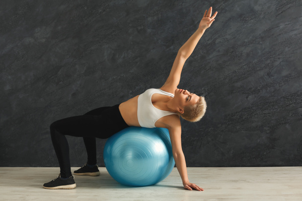 Fitness woman training with fitness ball indoors - Photo, Image