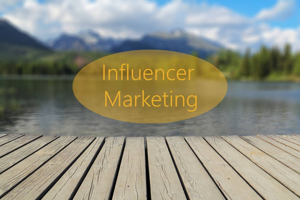 Influencer Marketing text, mountain lake in the background - Photo, Image