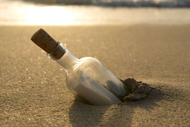 Message in a Bottle Half-Buried in Sand - Photo, Image