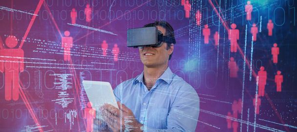 Businessman with tablet sitting on chair while using vr glasses against composite image of illustration of virtual data - Fotografie, Obrázek