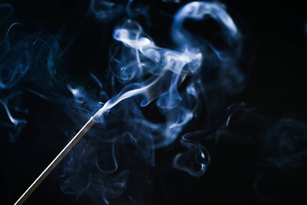on a black background smoke incense stick - Photo, image