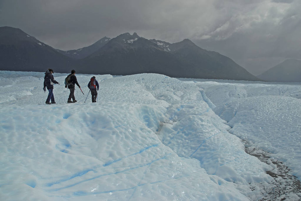 PATAGONIA ARGENTINA CIRCA FEBRUARY 2008.  Glacier trekking as these hikers are doing near Chalten, may be a thing of the past if global warming and climate change cause glaciers to melt and disappear. - 写真・画像
