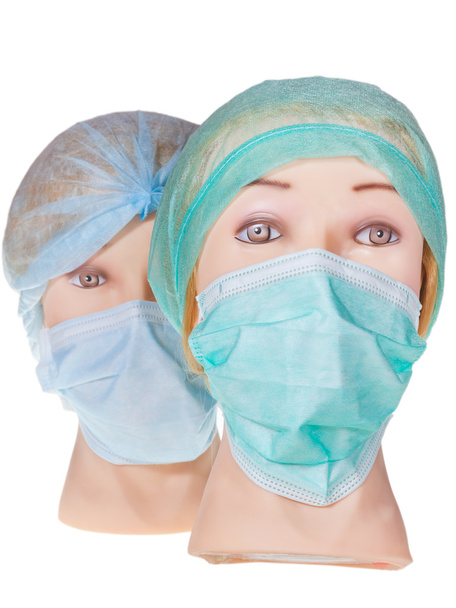 Dummy orvos fejek textil sebészeti sapkát és maszkot visel - Fotó, kép