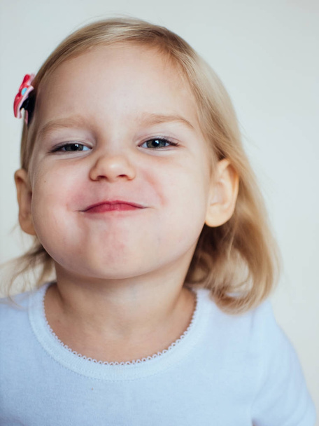 Portrait of emotional little girl. Happy blonde child - Фото, изображение