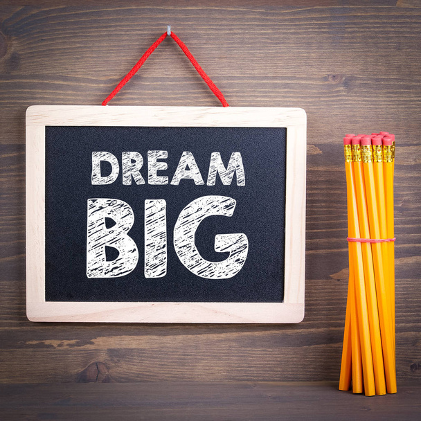 dream big. Chalkboard on a wooden background - Photo, Image