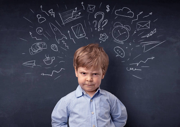 Little boy in front of a drawn up blackboard - Photo, Image