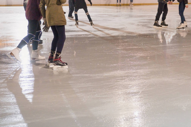 People skating in park on winter skating ice rink - Zdjęcie, obraz