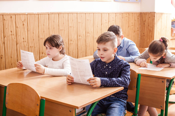 Children taking an exam - Фото, изображение