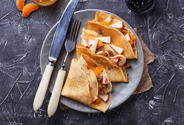 Pancakes crepes with different fruits and chocolate - Fotó, kép