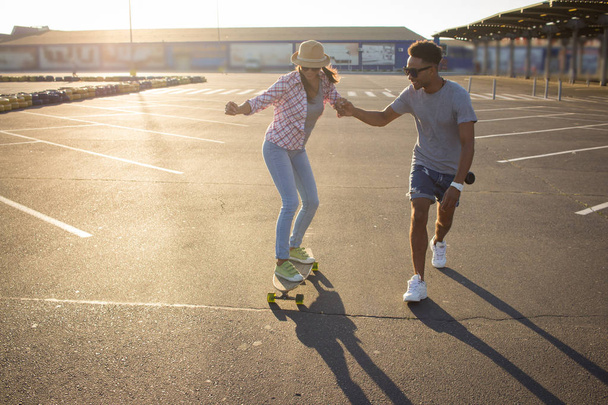Happy young couple with skateboard, concept of happiness, love and youth. - Foto, Bild
