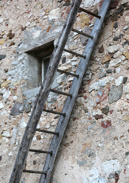 Ancient wooden ladder near the old house in the farm - Photo, Image