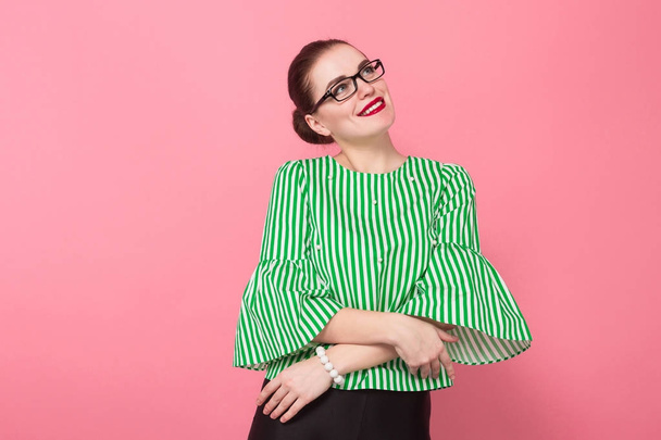 Beautiful young woman in stylish eyeglasses smiling on pink background  - Photo, Image