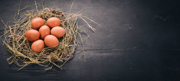 Chicken raw brown eggs. On a wooden background. Top view. Copy space. - Φωτογραφία, εικόνα