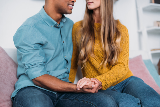 cropped image of multicultural couple holding hands - Photo, image