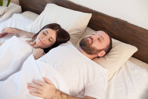 married couple sleeping in the bedroom - Photo, Image