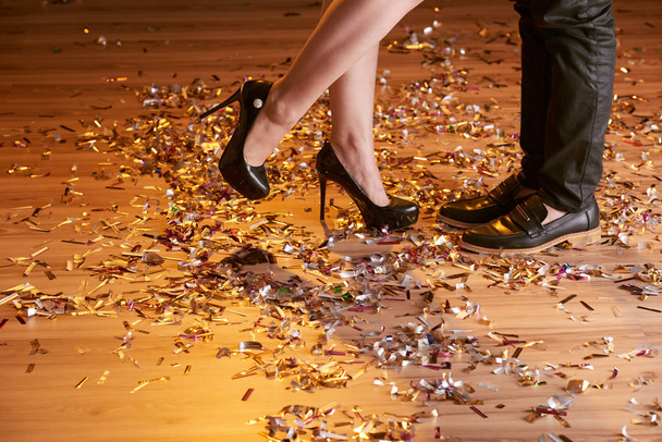 Feet of couple kissing at the party at night club - Valokuva, kuva