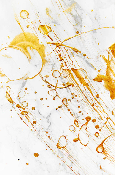  view of golden paint splashes on artists workplace  - 写真・画像