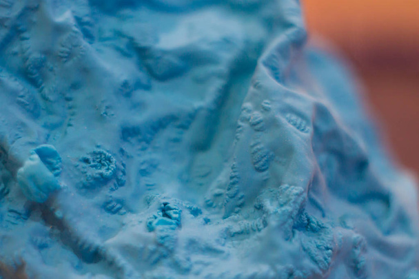 a close-up view of the compressed wrinkled rubber of a blue sea - Photo, Image