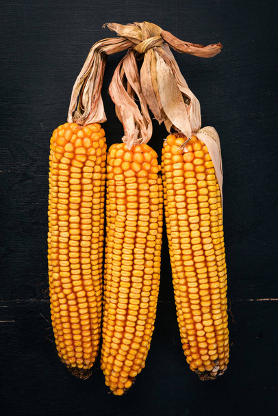 Dried corn on a wooden background. Top view. Copy space. - 写真・画像