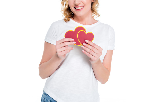 partial view of cheerful woman with heart shaped postcards isolated on white, st valentines day concept - Foto, afbeelding