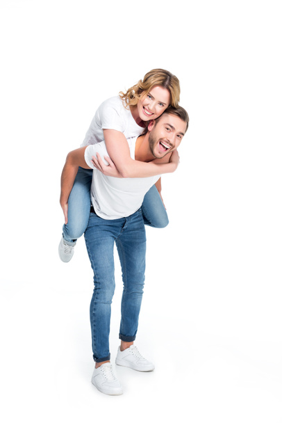 excited man piggybacking his girlfriend, isolated on white - Photo, Image