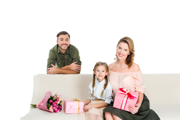 happy family with presents on sofa isolated on white - Zdjęcie, obraz