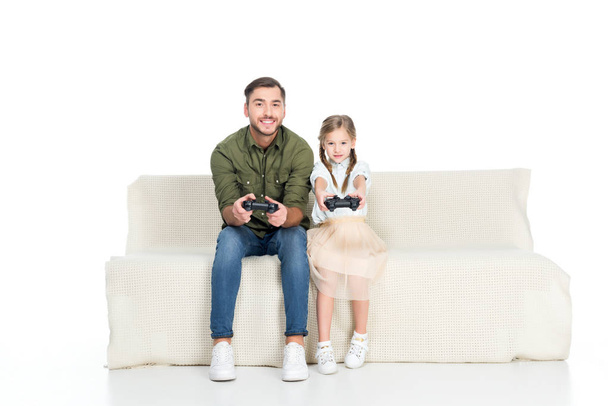 smiling father and daughter playing video game together isolated on white - Photo, Image