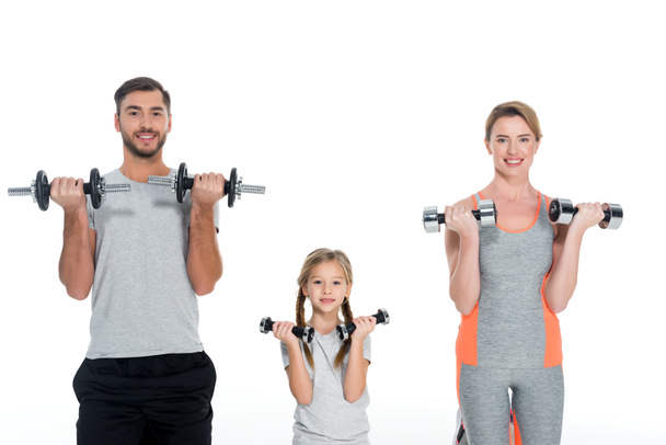 portrait of sportive parents and daughter with dumbbells isolated on white - Foto, Imagem