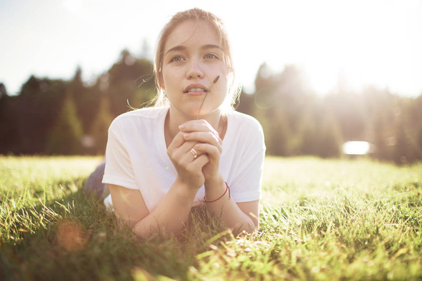 Young woman laying on the grass - Photo, Image